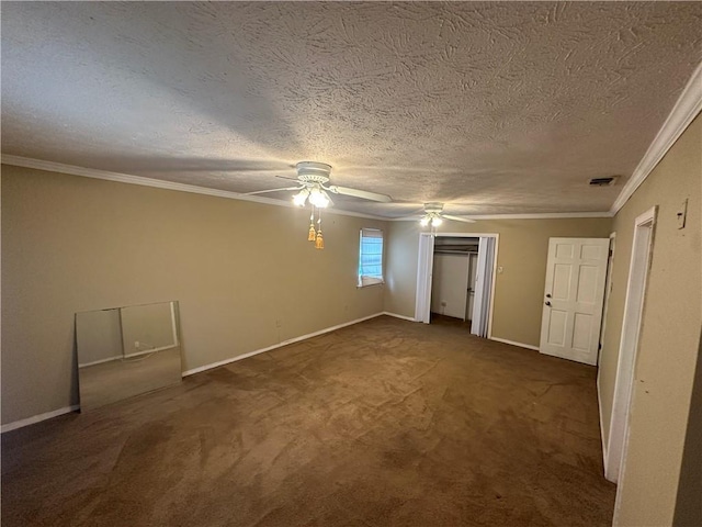 unfurnished bedroom featuring a ceiling fan, dark colored carpet, baseboards, ornamental molding, and a textured ceiling