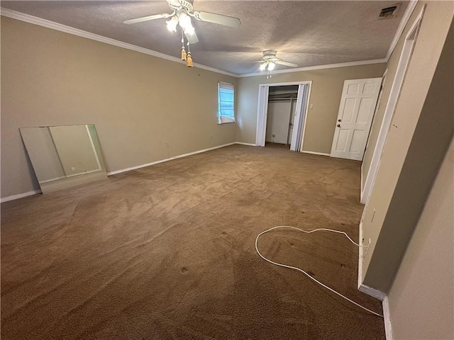 unfurnished bedroom featuring ornamental molding, carpet flooring, baseboards, visible vents, and a textured ceiling
