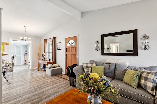 living room featuring visible vents, lofted ceiling with beams, baseboards, an inviting chandelier, and wood finished floors