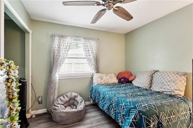 bedroom with baseboards, wood finished floors, and a ceiling fan
