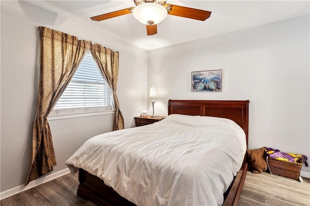 bedroom with wood finished floors, ceiling fan, and baseboards