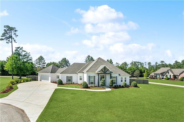 view of front of home with fence, a front lawn, concrete driveway, and an attached garage