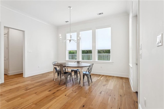 dining room with an inviting chandelier, visible vents, light wood finished floors, and baseboards