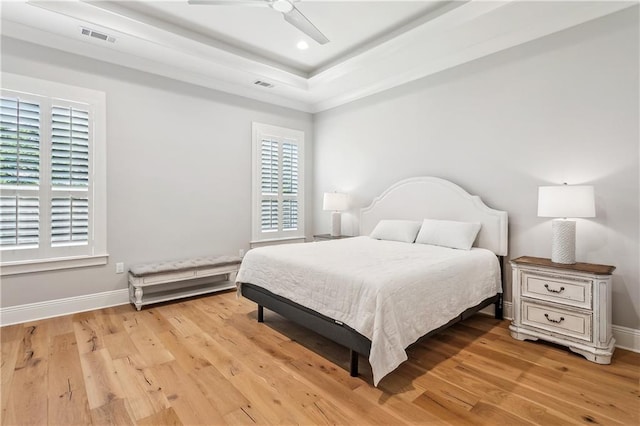 bedroom with baseboards, visible vents, and light wood-type flooring