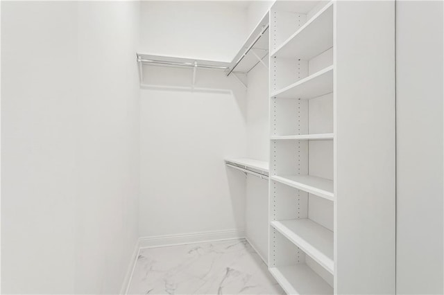 spacious closet with marble finish floor