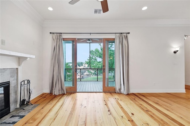 386 Marina Blvd, Mandeville, LA 70471 - unfurnished living room with ceiling fan, ornamental molding, wood-type flooring, baseboards, and a tiled fireplace