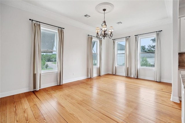 386 Marina Blvd, Mandeville, LA 70471 - unfurnished dining area with a chandelier, light wood-type flooring, baseboards, and ornamental molding