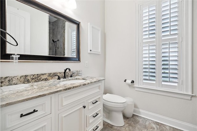 386 Marina Blvd, Mandeville, LA 70471 - full bathroom featuring baseboards, vanity, toilet, and a shower