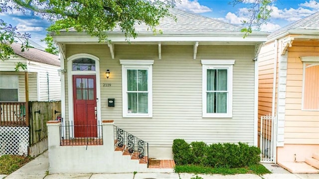 2119 Bienville St, New Orleans, LA 70112 - doorway to property with fence and a shingled roof