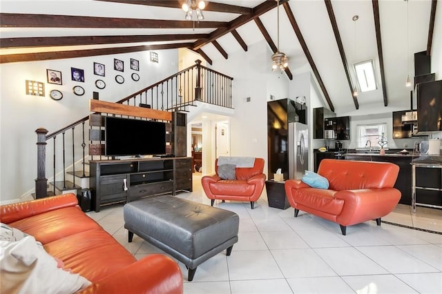 living room featuring beam ceiling, a ceiling fan, stairs, and light tile patterned flooring
