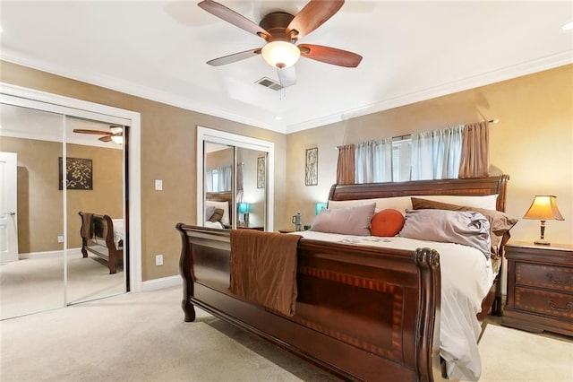 bedroom featuring crown molding, visible vents, light carpet, baseboards, and multiple closets