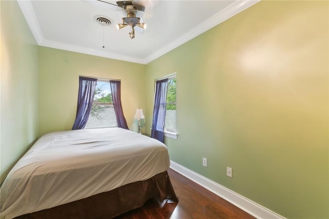 bedroom with visible vents, ornamental molding, dark wood finished floors, and baseboards