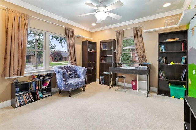 living area featuring baseboards, ornamental molding, a ceiling fan, and carpet floors