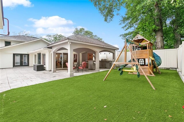 exterior space with a patio, a yard, a playground, and a fenced backyard