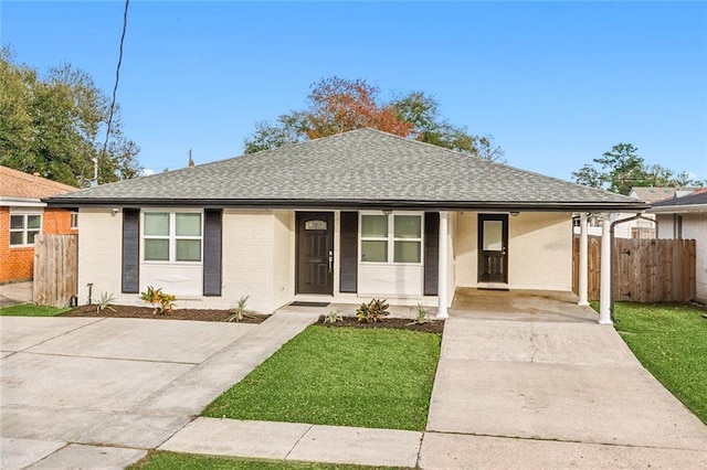 745 Oaklawn Dr, Metairie, LA 70005 - ranch-style home with driveway, covered porch, roof with shingles, brick siding, and an attached carport