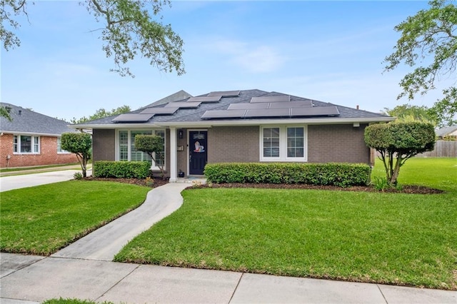 535 Amethyst St, New Orleans, LA 70124 - view of front of home with brick siding, roof mounted solar panels, and a front yard