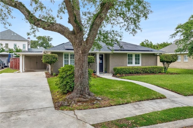 535 Amethyst St, New Orleans, LA 70124 - ranch-style home featuring a carport, concrete driveway, solar panels, and a front yard
