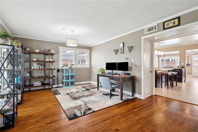 535 Amethyst St, New Orleans, LA 70124 - home office with baseboards, visible vents, ornamental molding, and wood finished floors