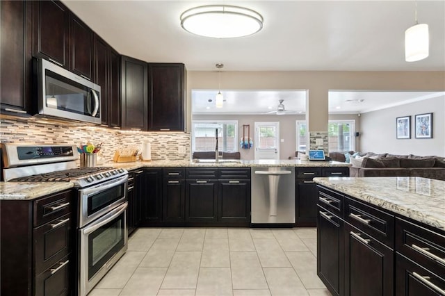 535 Amethyst St, New Orleans, LA 70124 - kitchen featuring tasteful backsplash, a sink, open floor plan, stainless steel appliances, and light tile patterned flooring