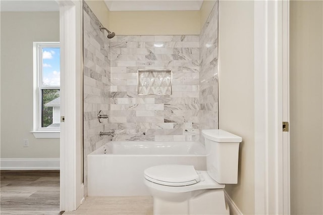 full bathroom with toilet, baseboards, and shower / washtub combination