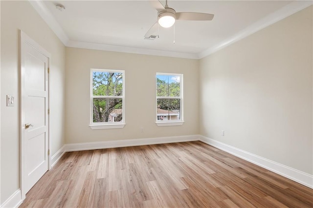 unfurnished room with visible vents, a ceiling fan, light wood finished floors, and baseboards