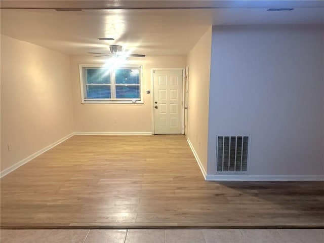 spare room with visible vents, a ceiling fan, light wood-style floors, and baseboards