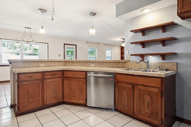 18 Landsdowne Ln, Destrehan, LA 70047 - kitchen featuring stainless steel dishwasher, hanging light fixtures, brown cabinets, and a sink
