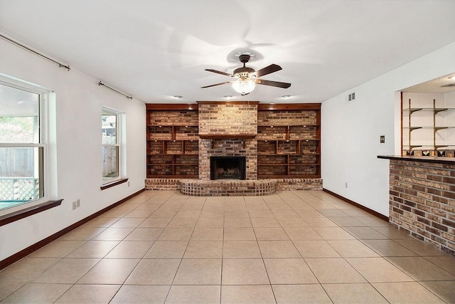18 Landsdowne Ln, Destrehan, LA 70047 - unfurnished living room with built in shelves, a brick fireplace, ceiling fan, baseboards, and tile patterned flooring