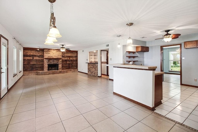 18 Landsdowne Ln, Destrehan, LA 70047 - kitchen featuring a fireplace, light tile patterned floors, built in shelves, a ceiling fan, and light countertops