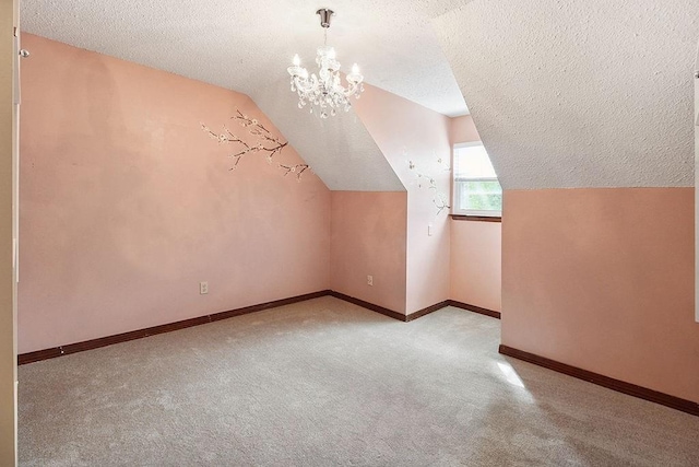 18 Landsdowne Ln, Destrehan, LA 70047 - additional living space with carpet, a textured ceiling, an inviting chandelier, and lofted ceiling