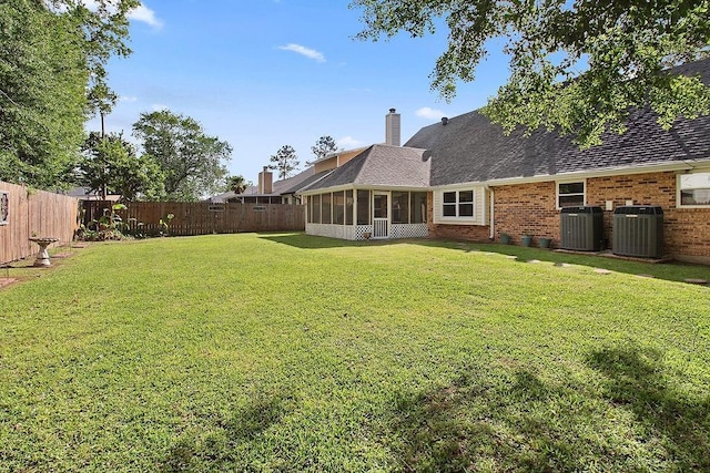 18 Landsdowne Ln, Destrehan, LA 70047 - view of yard featuring a fenced backyard, a sunroom, and central air condition unit