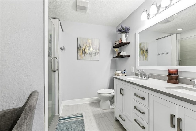 342 River Village Dr, Destrehan, LA 70047 - full bathroom with toilet, a stall shower, a textured ceiling, and a sink
