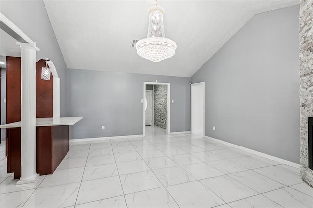 2140 Carol Sue Ave, Terrytown, LA 70056 - unfurnished living room with visible vents, a chandelier, vaulted ceiling, decorative columns, and marble finish floor