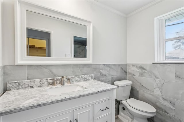 2140 Carol Sue Ave, Terrytown, LA 70056 - bathroom featuring tile walls, a wainscoted wall, toilet, vanity, and crown molding