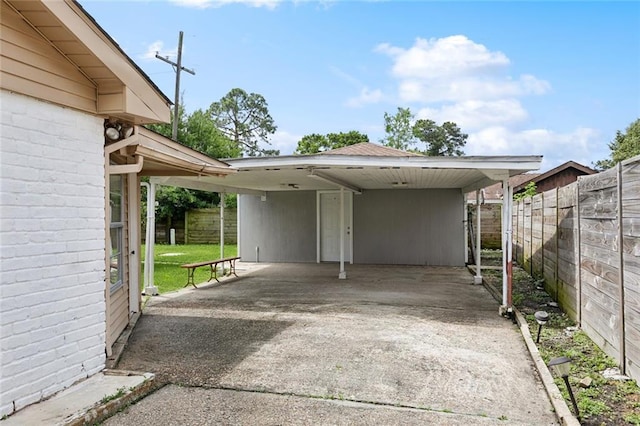 2140 Carol Sue Ave, Terrytown, LA 70056 - view of parking featuring fence, a carport, and concrete driveway