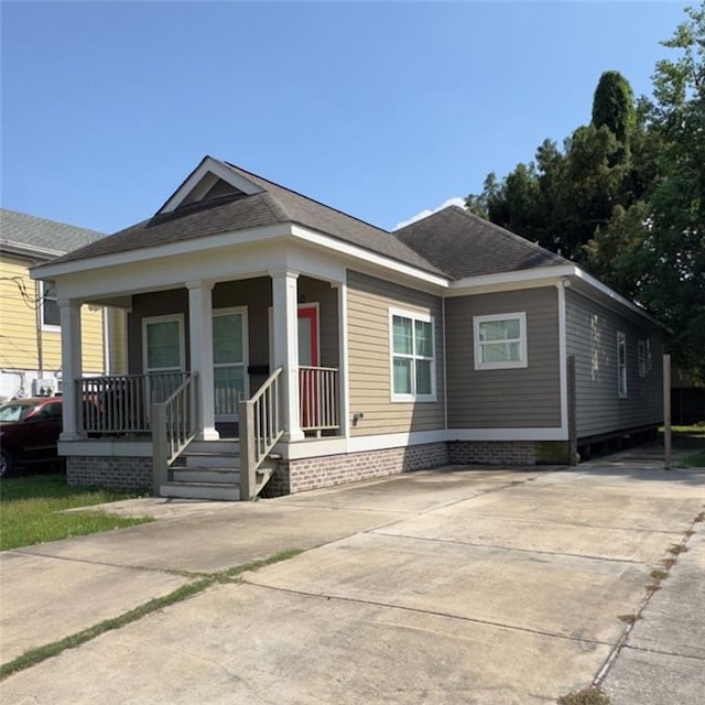 2680 Lavender St, New Orleans, LA 70122 - view of front of house featuring a porch, driveway, and roof with shingles