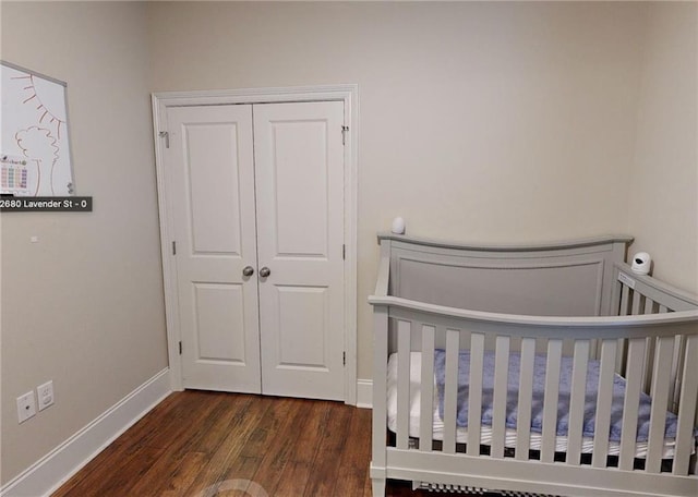 2680 Lavender St, New Orleans, LA 70122 - bedroom featuring dark wood finished floors, a closet, and a nursery area