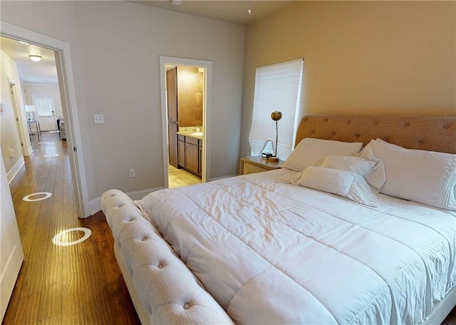 2680 Lavender St, New Orleans, LA 70122 - bedroom featuring light wood-style flooring and ensuite bathroom