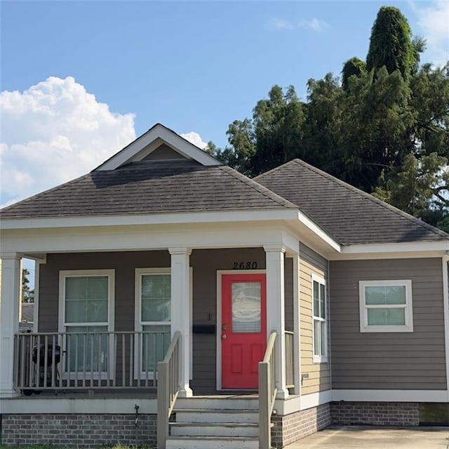 2680 Lavender St, New Orleans, LA 70122 - view of front facade featuring roof with shingles and a porch