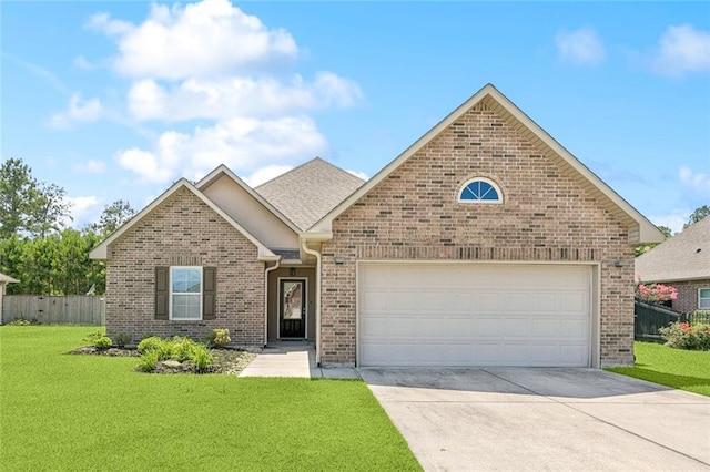 28230 Loiret Ct, Ponchatoula, LA 70454 - view of front facade with driveway, brick siding, and an attached garage