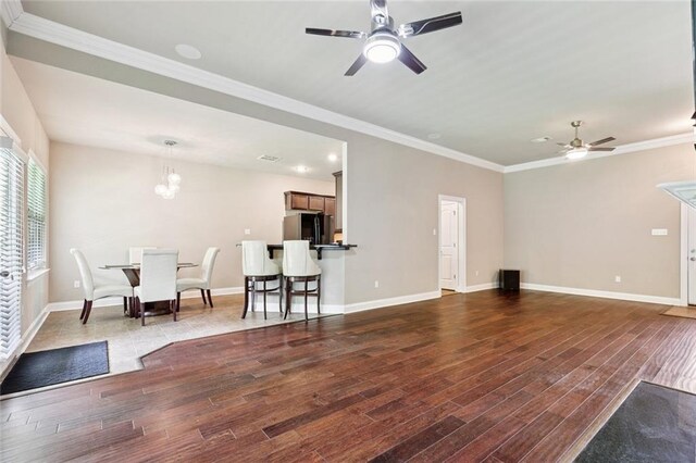 28230 Loiret Ct, Ponchatoula, LA 70454 - living area with a ceiling fan, wood finished floors, ornamental molding, and a chandelier