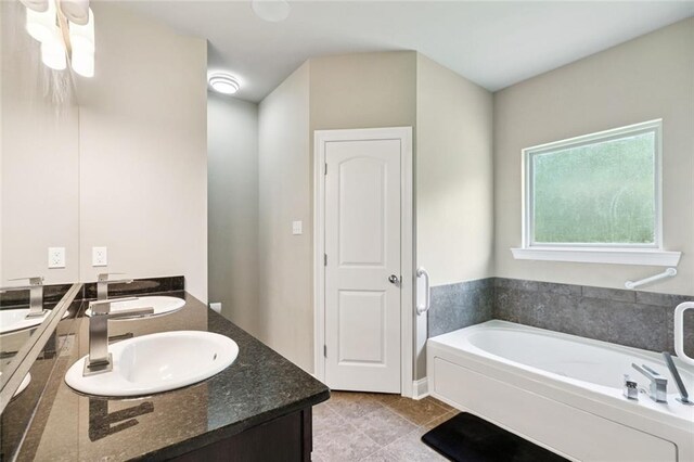 28230 Loiret Ct, Ponchatoula, LA 70454 - bathroom featuring double vanity, a bath, and tile patterned floors