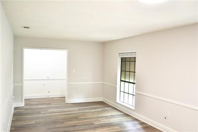 empty room with wood finished floors and baseboards