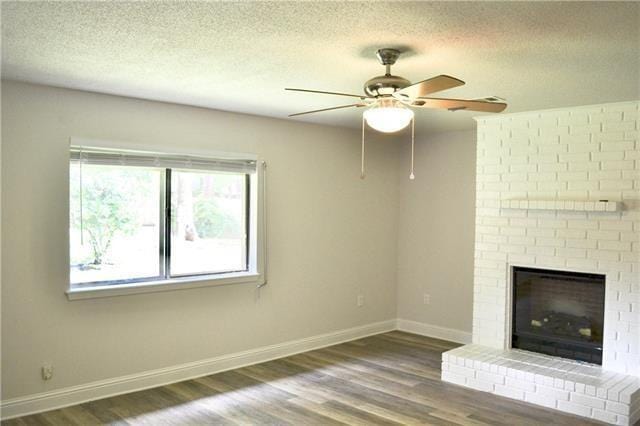 unfurnished living room with wood finished floors, ceiling fan, and a textured ceiling