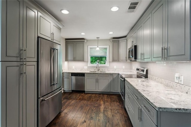 kitchen with gray cabinetry, visible vents, appliances with stainless steel finishes, and a sink