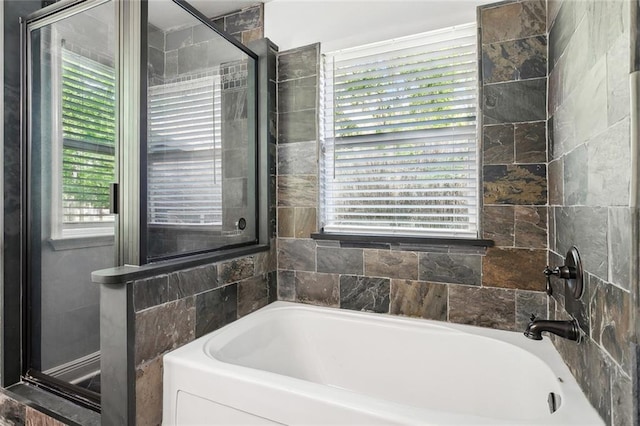 full bath featuring a garden tub and a shower
