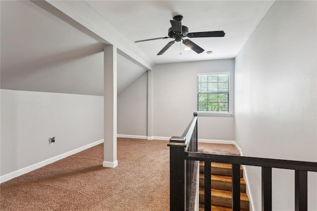 bonus room featuring lofted ceiling, a ceiling fan, carpet flooring, and baseboards