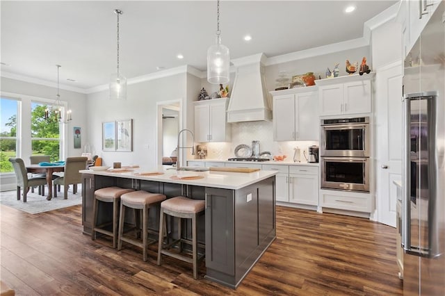 kitchen featuring stainless steel appliances, light countertops, ornamental molding, dark wood finished floors, and custom exhaust hood
