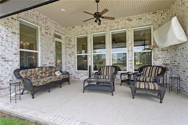 view of patio with an outdoor living space and ceiling fan