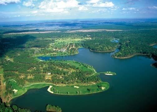 aerial view with view of golf course and a water view